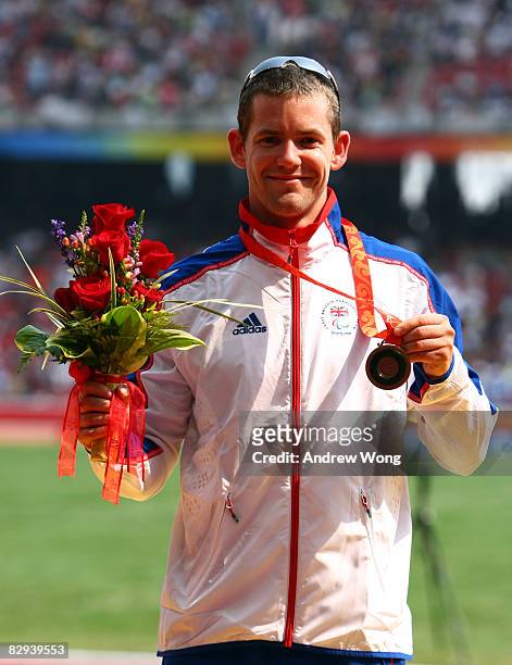 John McFall of Great Britain celebrates his bronze medal following the Men's 100m T42 Final Athletics event at the National Stadium during day eight...