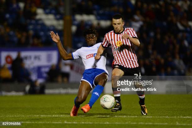 George Honeyman of Sunderland and Greg Leigh of Bury in action during the Carabao Cup First Round match between Bury and Sunderland at Gigg Lane on...