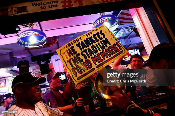 Fans celebrate the Yankees win after watching the last game at Yankee Stadium between the Baltimore Orioles and the New York Yankees across the...