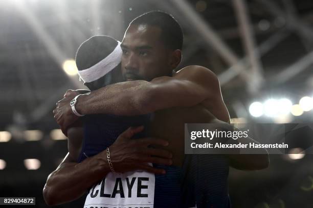 Christian Taylor gold and Will Claye silver of the United States celebrate with USA flag after the mens triple jump final during day seven of the...