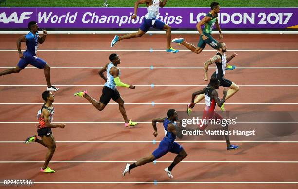 Ramil Guliyev of Turkey leads Jereem Richards of Trinidad and Tobago and Wayde van Niekerk of South Africa before he crosses the line to win the mens...