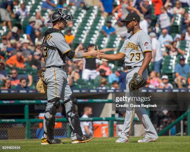 Chris Stewart of the Pittsburgh Pirates slaps hands with relief pitcher Felipe Rivero of the Pittsburgh Pirates after defeating the Tigers 7-5 during...