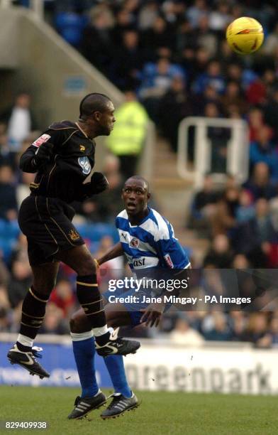 Jason Roberts of Wigan Athletic rises for a high ball watched by Ibrahima Sonko of Reading during the Coca-Cola Championship match at The Madejski...