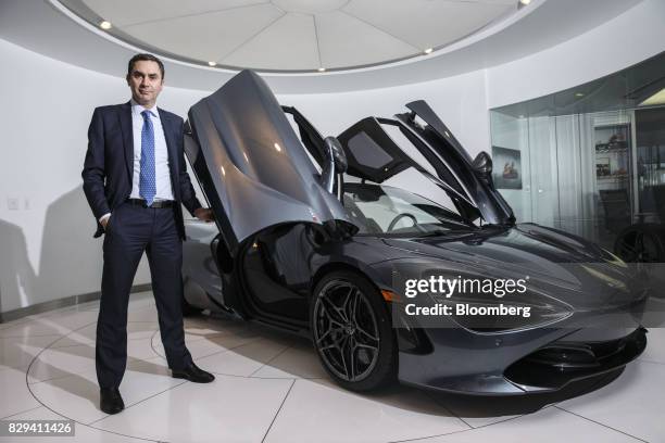 Pietro Frigeriom, owner of McLaren Newport Beach, stands for a photograph next to a McLaren Automotive Ltd. 720S vehicle at the dealership in Newport...