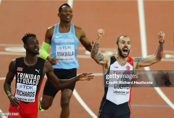 Ramil Guliyev of Turkey celebrates next to Jereem Richards of Trinidad and Tobago as he crosses the line to win the mens 200 metres final during day...