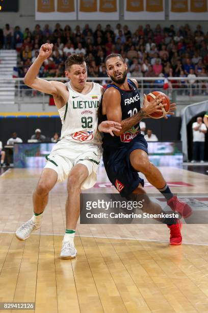 Evan Fournier of France is driving to the basket against Edgaras Ulanovas of Lithuania during the international friendly game between France v...