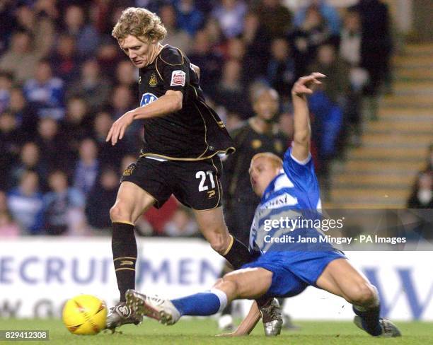 Reading's Steve Sidwell slides in to tackle Wigan Athletic's Jimmy Bullard during the Coca-Cola Championship match at The Madejski Stadium, Reading,...