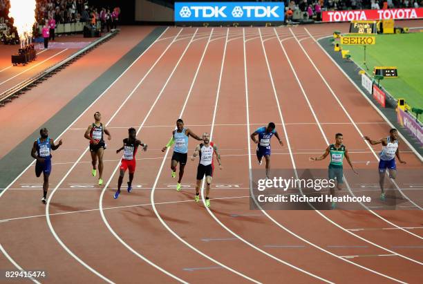 Ramil Guliyev of Turkey celebrates as he crosses the line to win also pictured are: Ameer Webb of the United States, Abdul Hakim Sani Brown of Japan,...