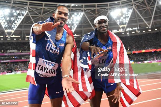 Athlete Christian Taylor celebrates with US athlete Will Claye after winning first and second place respectively in the final of the men's triple...