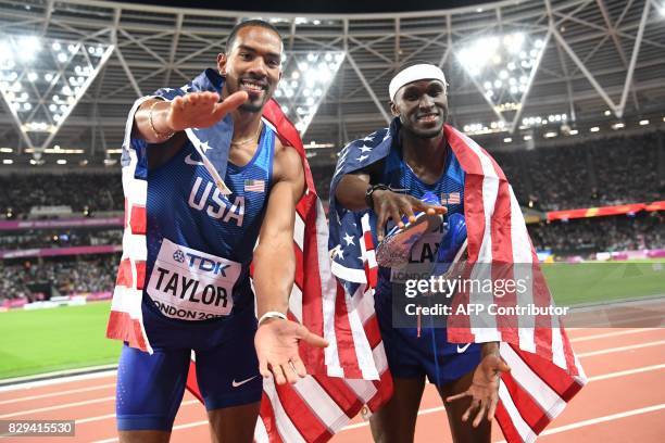 Athlete Christian Taylor celebrates with US athlete Will Claye after winning first and second place respectively in the final of the men's triple...