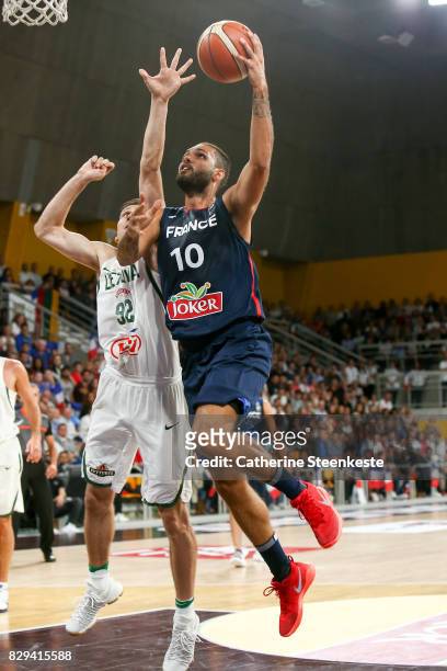 Evan Fournier of France is at the basket against Edgaras Ulanovas of Lithuania during the international friendly game between France v Lithuania at...
