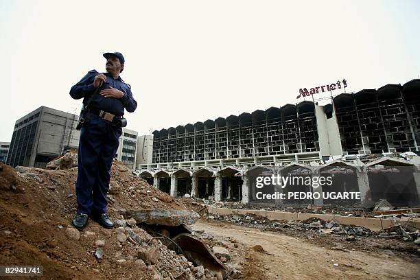 Pakistani security guard stands next to the the devastated Marriott Hotel in Islamabad on September 22, 2008 two days after a suicide truck bombing...