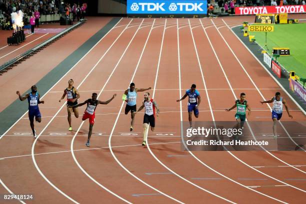 Ramil Guliyev of Turkey celebrates as he crosses the line to win also pictured are: Ameer Webb of the United States, Abdul Hakim Sani Brown of Japan,...