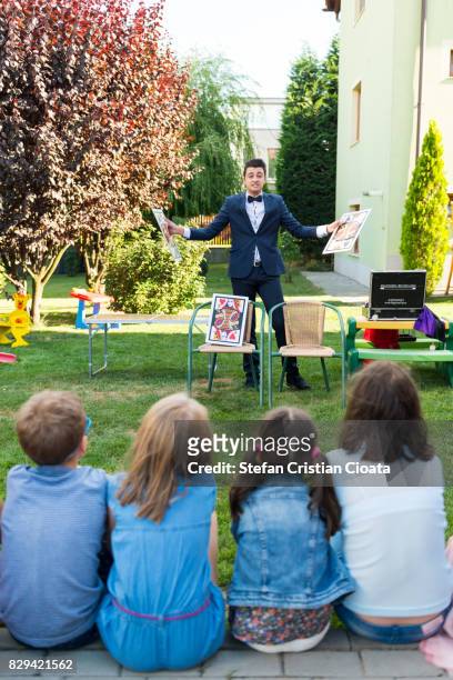 magician at birthday party - magician stock pictures, royalty-free photos & images