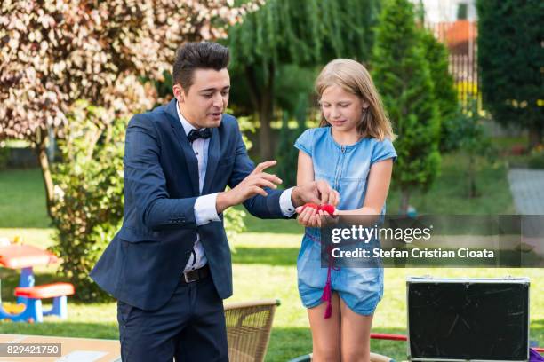 girl and magician - secret garden party stock pictures, royalty-free photos & images