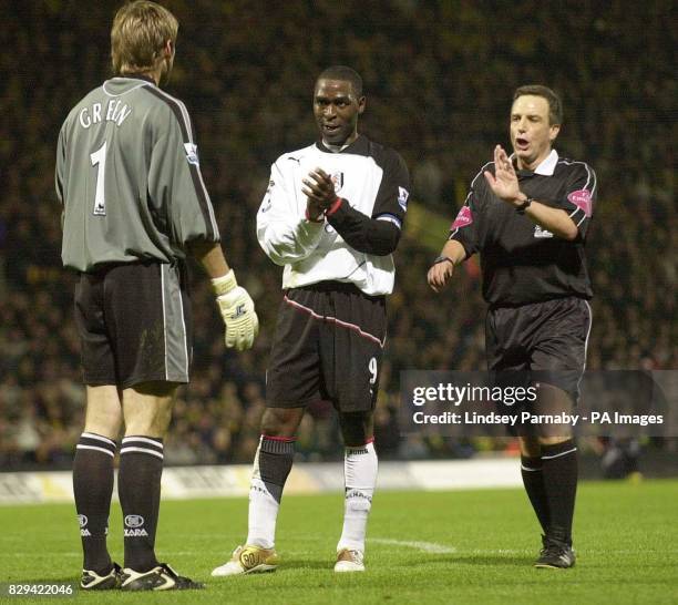 Fulham goalscorer Andy Cole taunts Norwich keeper Robert Green, forcing the referee to give Cole a yellow card during the Barclays Premiership match...