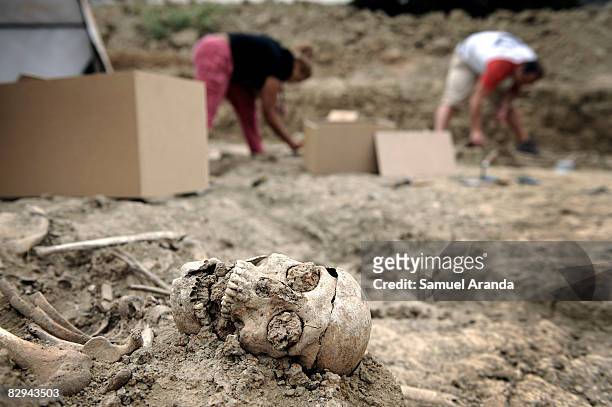 Human remains lay backdropped by archeologists exhuming the human remains at the San Rafael mass grave where an estimated of 4500 bodies where found,...
