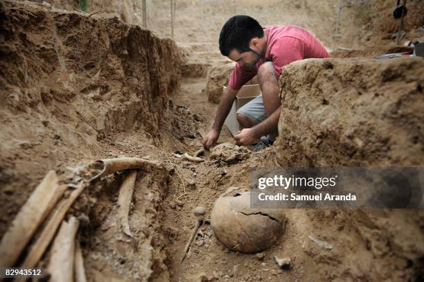 An Archologist works exhuming human remains at the San Rafael mass grave where an estimated of 4500 bodies where found, September 9, 2008 in Malaga,...