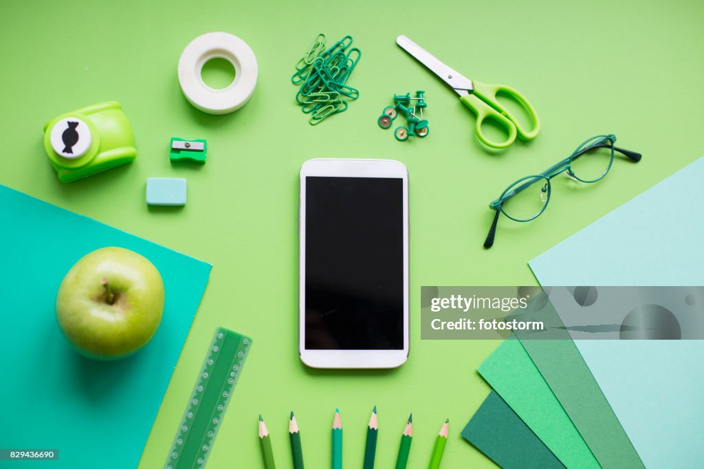 School supplies on green background