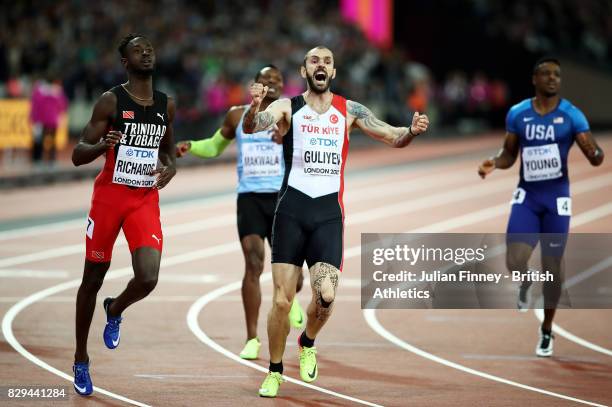 Ramil Guliyev of Turkey celebrates next to Jereem Richards of Trinidad and Tobago as he crosses the line to win the mens 200 metres final during day...