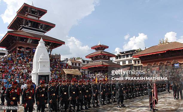 Nepalese devotees gather to pay homage to the Kumari, a pre-pubescent girl revered by many in Nepal as a living goddess, as security forces keep...