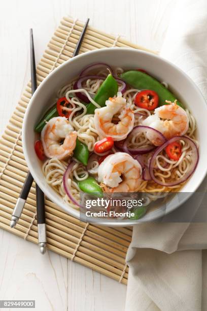 asian food: noodle soup with shrimps, onion, sugarsnap and chilli still life - noodle soup stock pictures, royalty-free photos & images