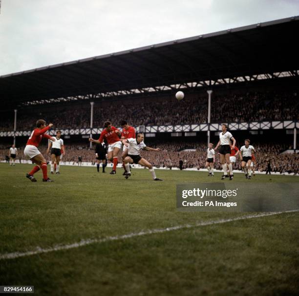 S Vladimir Ponomarev heads for goal as he and teammate Valeri Voronin tower above West Germany's Willi Schulz , watched by teammate Eduard Malofeev...