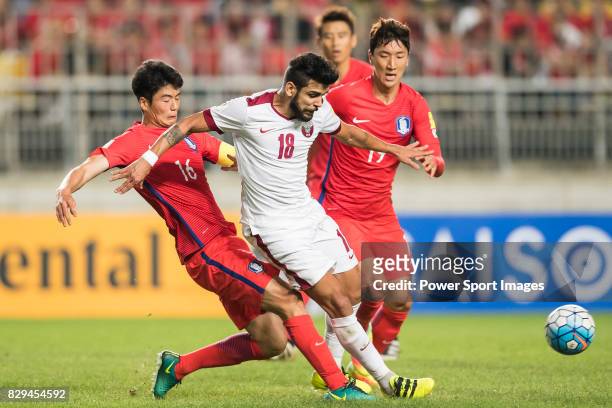 Luiz Junior of Qatar fights for the ball with Ki Sungyueng and Jung Wooyoung of Korea Republic during the 2018 FIFA World Cup Russia Asian Qualifiers...