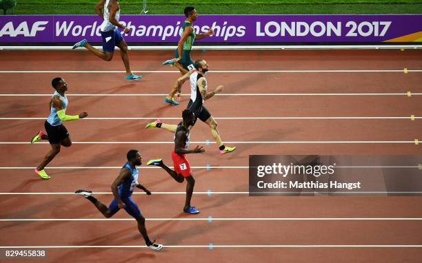 Ramil Guliyev of Turkey leads Jereem Richards of Trinidad and Tobago and Wayde van Niekerk of South Africa before he crosses the line to win the mens...