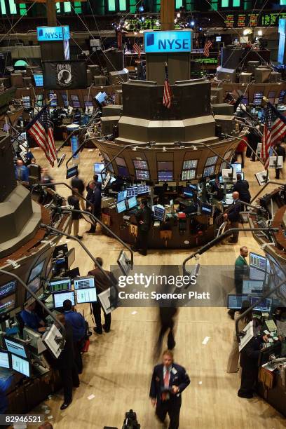 Traders work on the floor of the New York Stock Exchange after ringing the opening bell September 22, 2008 in New York City. After weekend...