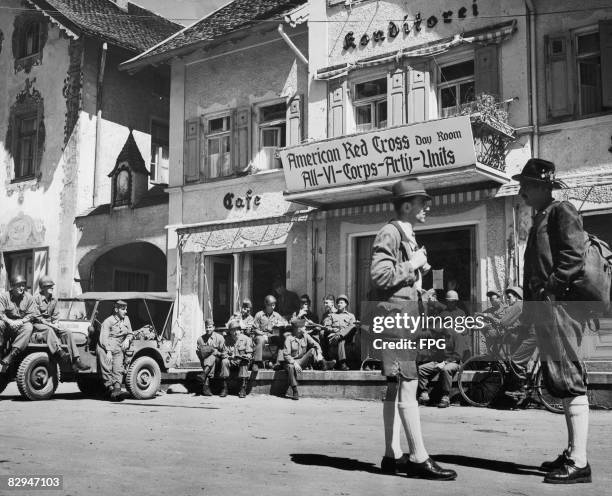 Locals and US servicemen outside a bakery and cafe run by the American Red Cross in the occupied German town of Starnberg, Bavaria, June 1945.