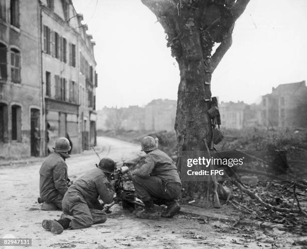 American Combat Engineers manning a machine gun against German snipers in Metz, France, 22nd November 1944. The men are members of the 166th US Army...