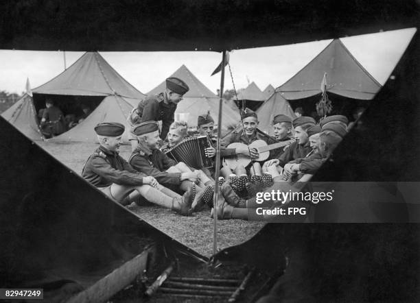 Boys enjoying a sing-song at a campsite on Luneberg Heath, 26th September 1936. The boys are members of the elite Nazi military academy, the National...