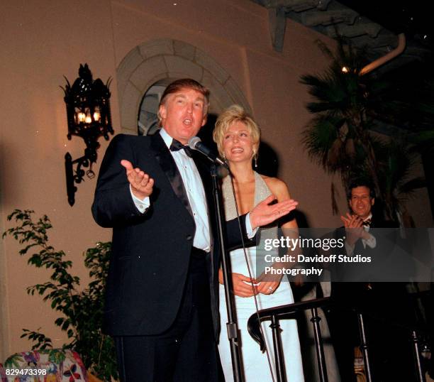 View of married American couple, real estate developer Donald Trump and actress Marla Maples, on stage during the official opening party of the...