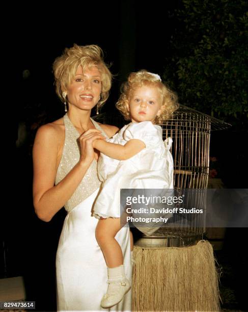 Portrait of actress Marla Maples as she holds her daughter, Tiffany, during the official opening party of the Mar-a-Lago Club.
