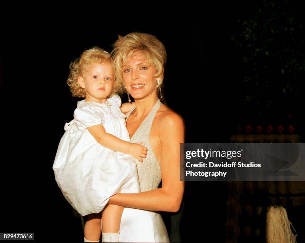 Portrait of actress Marla Maples as she holds her daughter, Tiffany, during the official opening party of the Mar-a-Lago Club.