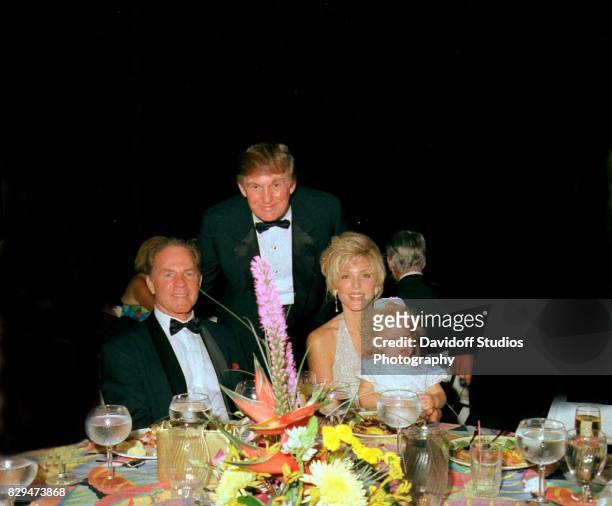 Portrait of, from left, sports broadcaster & former football player Frank Gifford , and married couple, real estate developer Donald Trump and Marla...