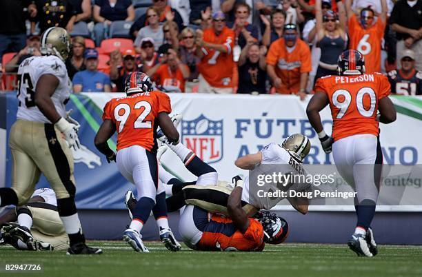 Quarterback Drew Brees of the New Orleans Saints is sacked by the Denver Broncos during NFL action at Invesco Field at Mile High on September 21,...