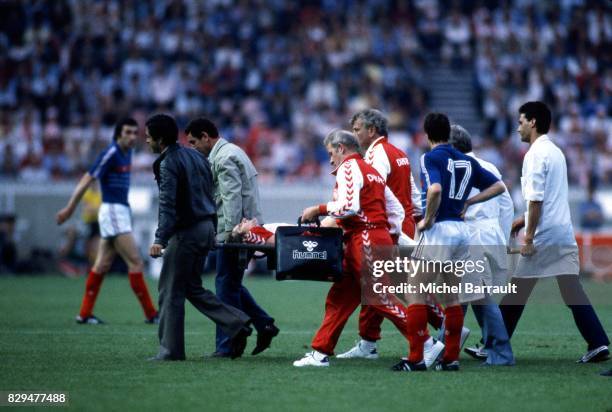 Allan Simonsen of Denmark leave the pitch is injured during the European Championship match between France and Denmark at Parc des Princes, Paris,...