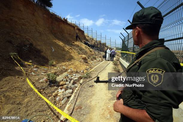 Algerian rescue workers inspect the site of a helicopter crash, Bel 206, belonging to Tassili Airlines, which killed four people, on August 10 in...