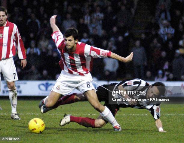 Grimsby Town's Thomas Pinault and Lincoln City's Richard Butcher in action