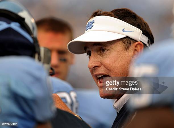 Head coach Butch Davis of North Carolina speaks with his players during a timeout in the college football game against Virginia Tech at Kenan Stadium...