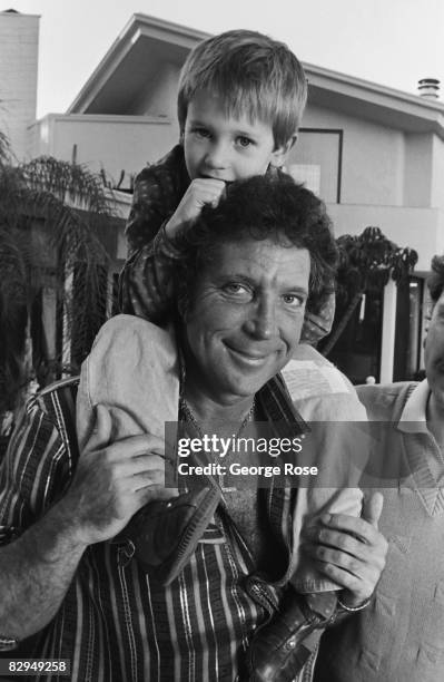 Welsh singer and popular Las Vegas musical act, Tom Jones, poses with one of his grand kids during a 1987 Los Angeles, California, photo portrait...