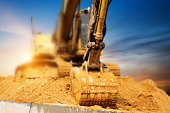 Excavators machine in construction site on sunset background