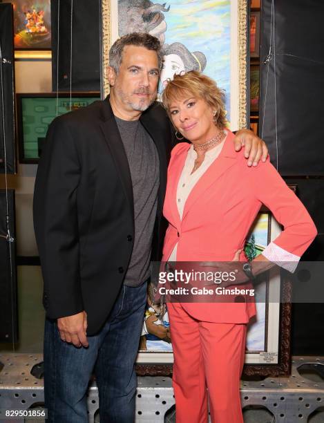 Actor/director Robby Benson and voice actress and Disney fine artist Paige O'Hara attend a preview event at the Magical Memories Fine Art Gallery...