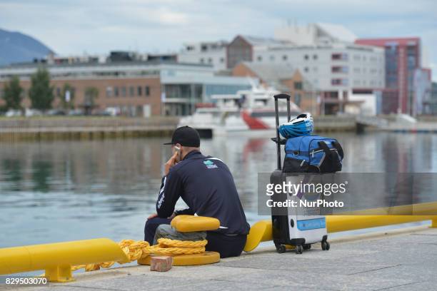 Member of Delko Marseille Provence KTM team awaiting for a boat in Harstad Harbour to be transported to the start at Andorja Island, ahead of the...