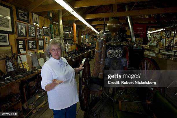 Sherri Schulze, curator at the Penn Brad Oil Museum in Bradford, Pennsylvania, holds a jar of Bradford produced crude oil while standing next to an...