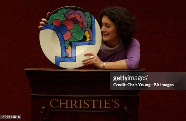 Christie's employee Zoe Schoon holds an 18 inch Latona Dahlia charger. The dish was originally bought at a car boot sale for 1 in the Manchester area...
