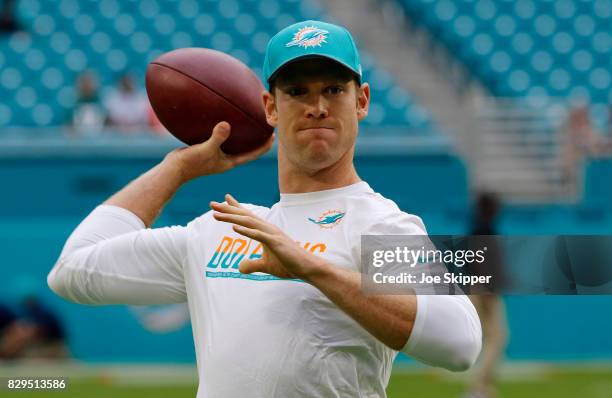 Ryan Tannehill of the Miami Dolphins throws during warmups before the Dolphins played against the Atlanta Falcons at Hard Rock Stadium on August 10,...