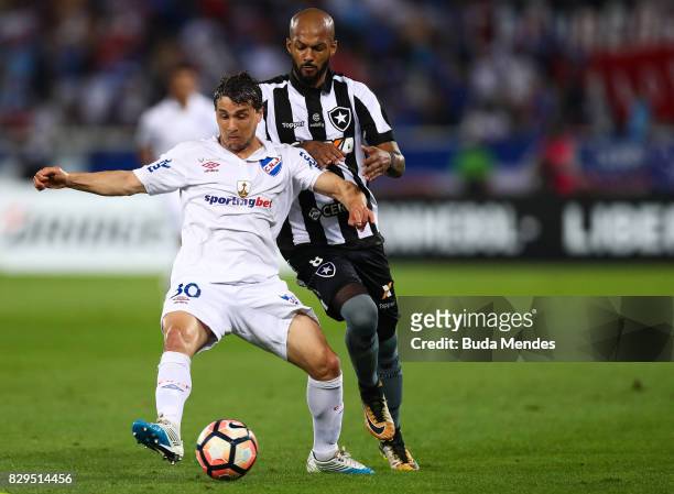 Bruno Silva of Botafogo struggles for the ball with Sebastian Fernandez of Nacional URU during a match between Botafogo and Nacional URU as part of...